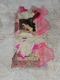 Artistic collage with pink and white elements on a textured background